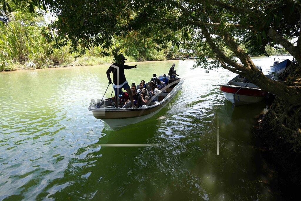 Fernando Vergara Migrants arrive on a boat to Acandi, Colombia, Tuesday, Sept. 14, 2021. The migrants, following a well-beaten, multi-nation journey towards the U.S., will continue their journey through the jungle known as the Darien Gap. (AP Photo/Fernando Vergara)