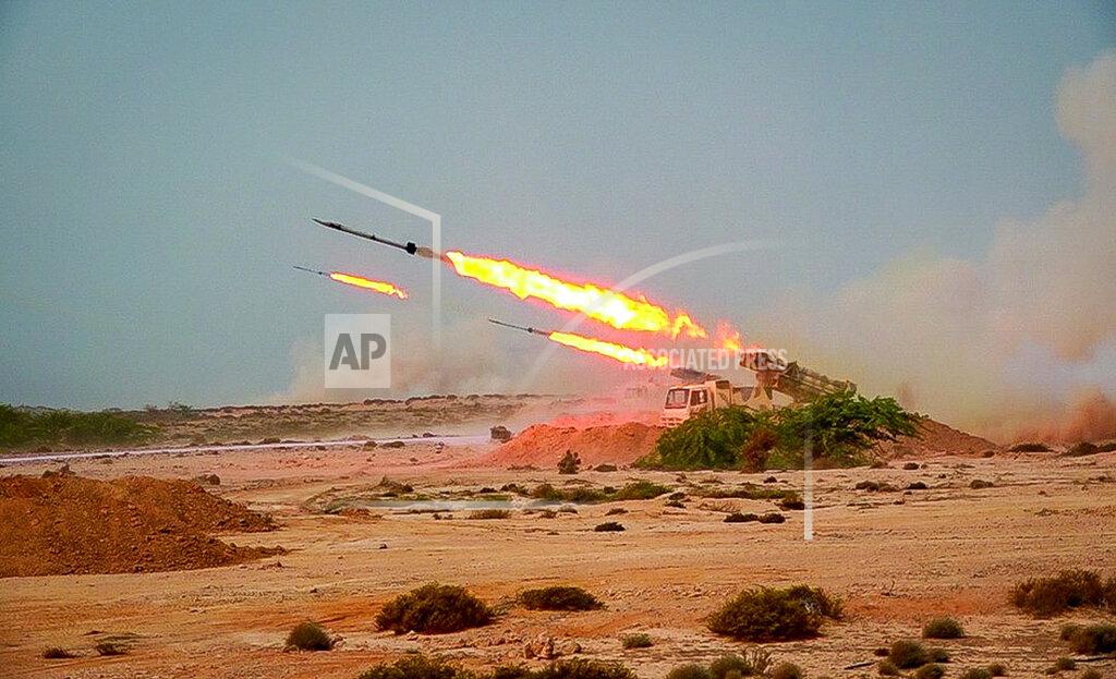 Uncredited In this photo released Tuesday, July 28, 2020, by Sepahnews, missiles are fired in a Revolutionary Guard military exercise. Iran's paramilitary Revolutionary Guard fired a missile from a helicopter targeting the mock-up aircraft carrier in the strategic Strait of Hormuz. That's according to footage aired on state television on Tuesday. Iranian commandos also fast-roped down from a helicopter onto the replica in the footage from the exercise called "Great Prophet 14." The drill appears aimed at threatening the U.S. amid tensions between Tehran and Washington. (Sepahnews via AP)
