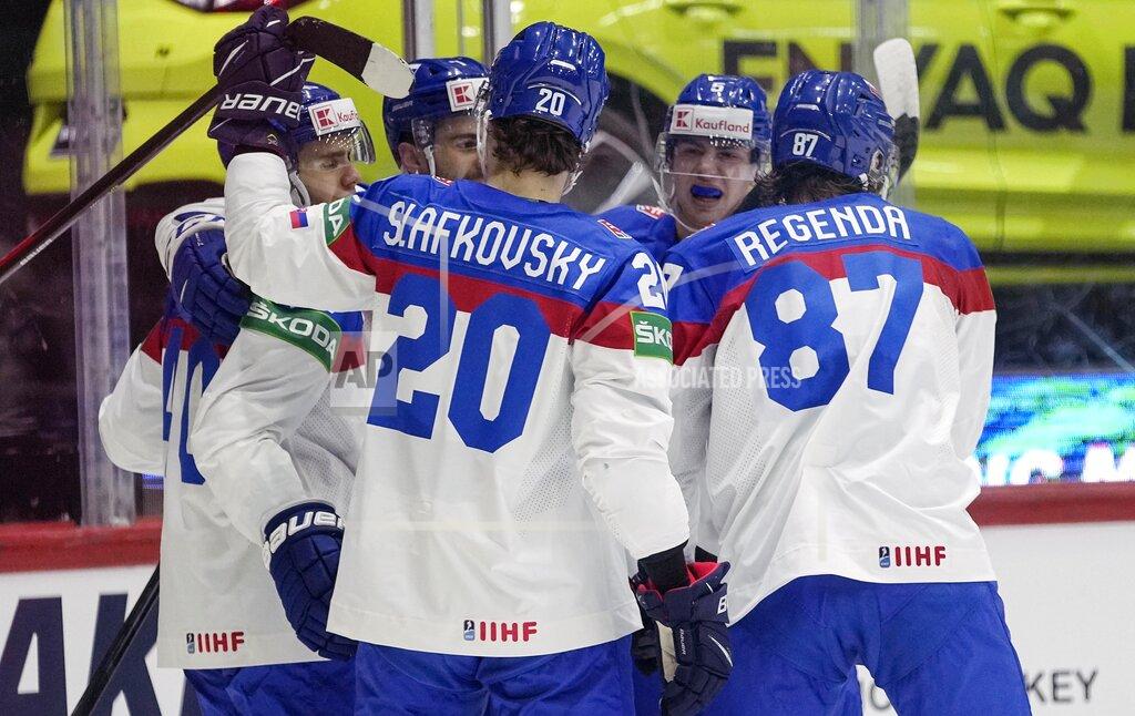 Martin Meissner Slovakia's Pavol Regenda, right, celebrates with his team after he scored the opening goal during the group A Hockey World Championship match between France and Slovakia in Helsinki, Finland, Friday May 13, 2022. (AP Photo/Martin Meissner)