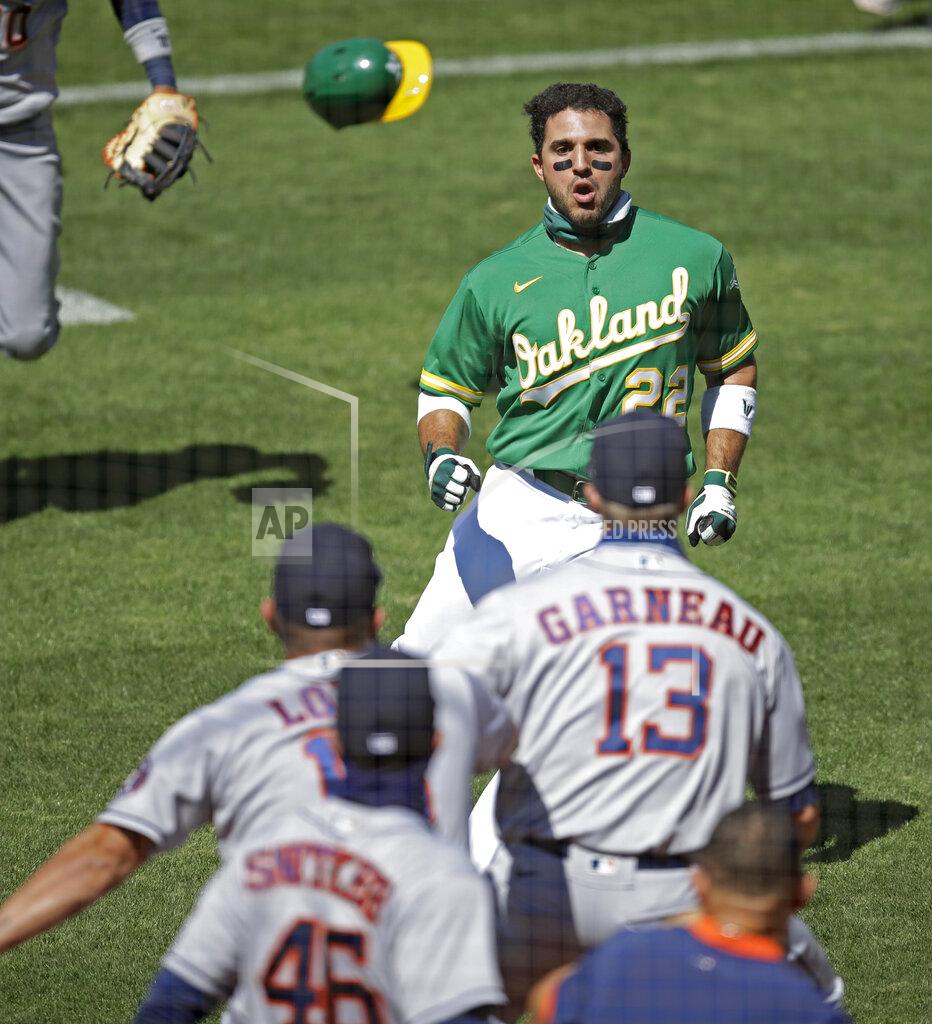 Ben Margot Oakland Athletics' Ramon Laureano (22) charges the Houston Astros' dugout after being hit by a pitch thrown by Humberto Castellanos during the seventh inning of a baseball game Sunday, Aug. 9, 2020, in Oakland, Calif. (AP Photo/Ben Margot)