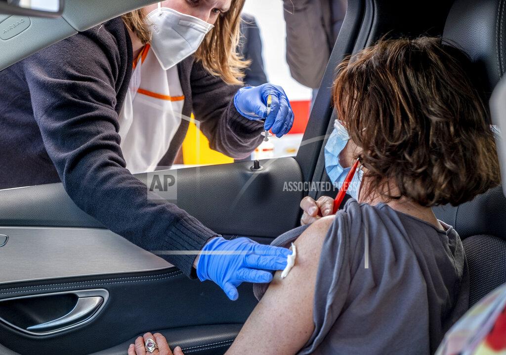 Michael Probst A woman sits in a car as she is vaccinated with AstraZeneca in a tent on the parking lot of a supermarket in Pforzheim, southern Germany, Wednesday, May 5, 2021. A doctor who could not get rid of her AstraZeneca vaccine in her doctor's office decided to offer some 250 doses in drive-in location at the supermarket. (AP Photo/Michael Probst)