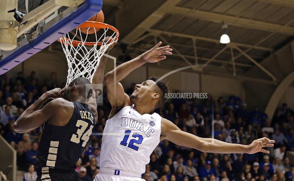 Gerry Broome Duke's Javin DeLaurier (12) defends against Wake Forest's Sunday Okeke (34) during the first half of an NCAA college basketball game in Durham, N.C., Tuesday, March 5, 2019. (AP Photo/Gerry Broome)