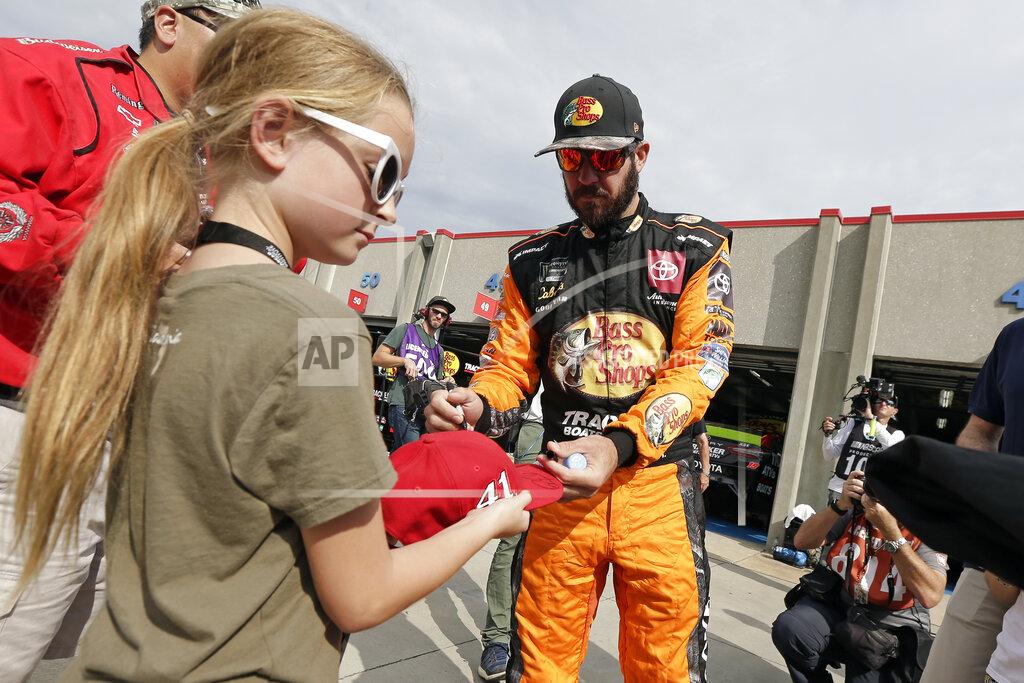 Gerry Broome Martin Truex Jr. signs autographs for fans during practice prior to Sunday's NASCAR Cup Series auto race at Charlotte Motor Speedway in Concord, N.C., Saturday, Sept. 28, 2019. (AP Photo/Gerry Broome)