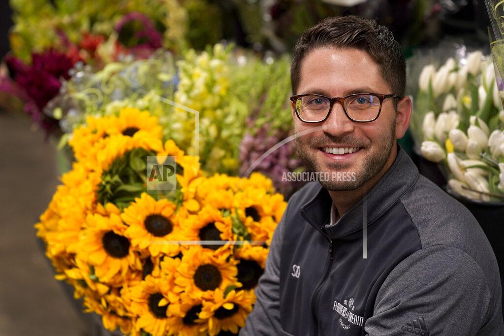Charles Rex Arbogast Steven Dyme, owner of Flowers for Dreams, poses for a portrait at his warehouse Friday, July 23, 2021, in Chicago. Dyme says the $15 minimum made it much easier to staff up when the economy reopened this spring and demand for flowers, particularly for weddings, soared. The company has four locations, including its headquarters in Chicago, one in Milwaukee, and two in Detroit. (AP Photo/Charles Rex Arbogast)