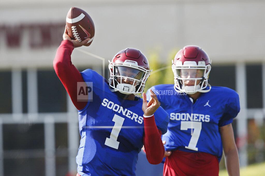 Sue Ogrocki FILE - In this Monday, Aug. 5, 2019, file photo, Oklahoma quarterback Jalen Hurts (1) throws as quarterback Spencer Rattler watches during the NCAA college football team's practice in Norman, Okla. Oklahoma coach Lincoln Riley has chosen Hurts as his starting quarterback for the Sept. 1 season opener against Houston over Rattler and Tanner Mordecai. (AP Photo/Sue Ogrocki, File)