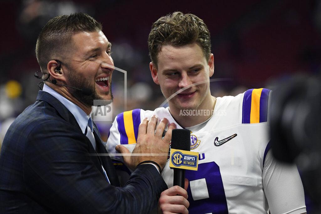 Danny Karnik LSU quarterback Joe Burrow (9) speaks with former NFL player Tim Tebow after the Peach Bowl NCAA semifinal college football playoff game against Oklahoma, Saturday, Dec. 28, 2019, in Atlanta. LSU won 63-28. (AP Photo/Danny Karnik)