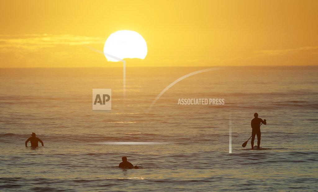 Mark Baker Surfers enjoy a sunrise surf at Sumner Beach as level four COVID-19 restrictions are eased in Christchurch, New Zealand, Tuesday, April 28, 2020. New Zealand eased its strict lockdown restrictions to level three at midnight to open up certain sections of the economy but social distancing rules will still apply. (AP Photo/Mark Baker)