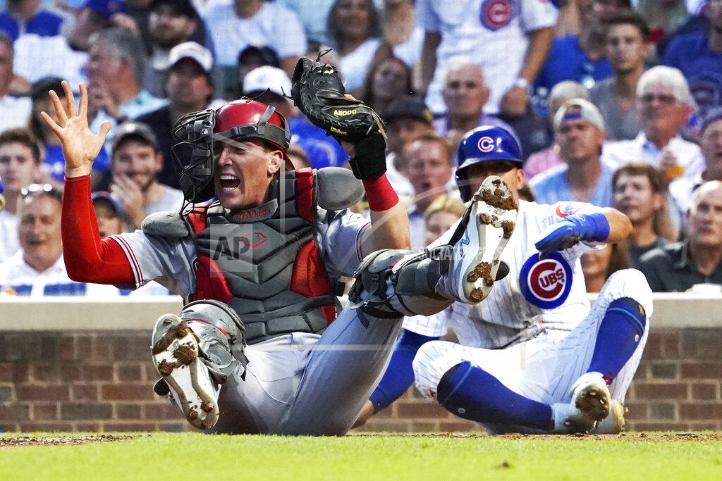 David Banks Cincinnati Reds catcher Tyler Stephenson holds up the glove and ball after tagging out Chicago Cubs' Rafael Ortega, right, during the third inning of a baseball game Tuesday, July 27, 2021, in Chicago. (AP Photo/David Banks)