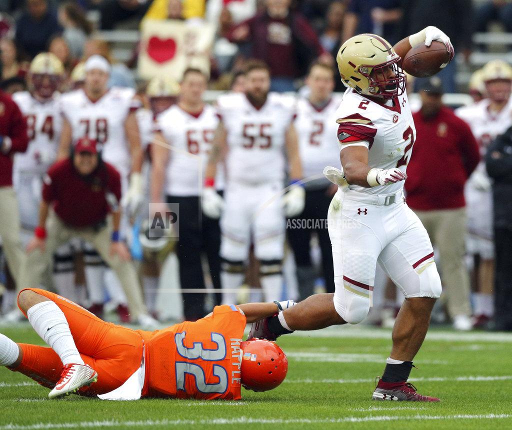 Richard W. Rodriguez Boston College running back AJ Dillon (2) breaks a tackle by Boise State safety Jordan Happle (32) on a touchdown run during the first half of the First Responder Bowl NCAA football game Wednesday, Dec. 26, 2018, in Dallas. (AP Photo/Richard W. Rodriguez)