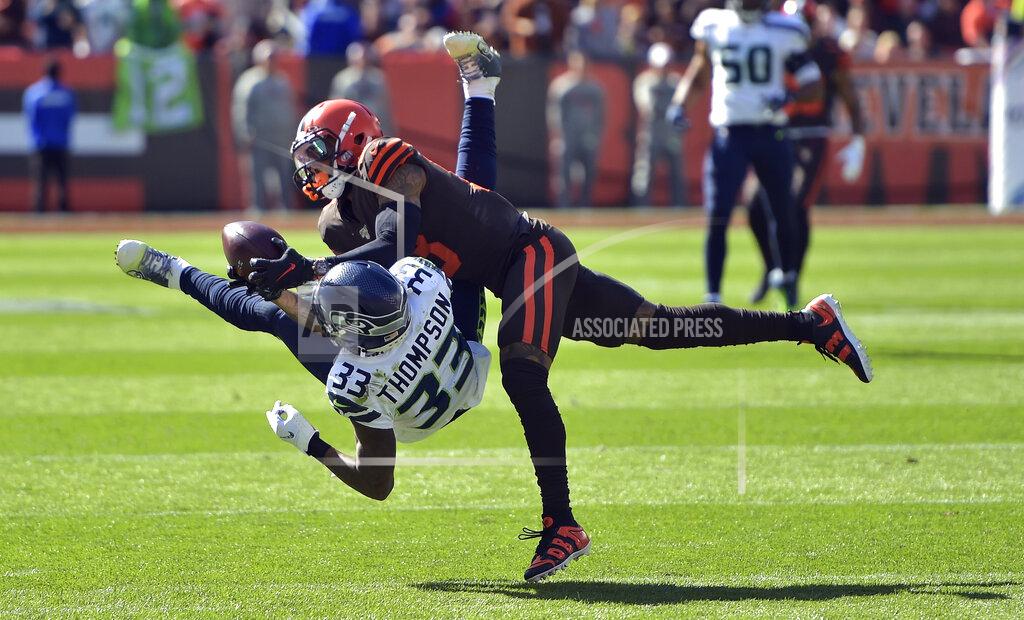 David Richard Cleveland Browns wide receiver Odell Beckham Jr. (13) catches a pass under pressure from Seattle Seahawks free safety Tedric Thompson (33) during the first half of an NFL football game, Sunday, Oct. 13, 2019, in Cleveland. (AP Photo/David Richard)