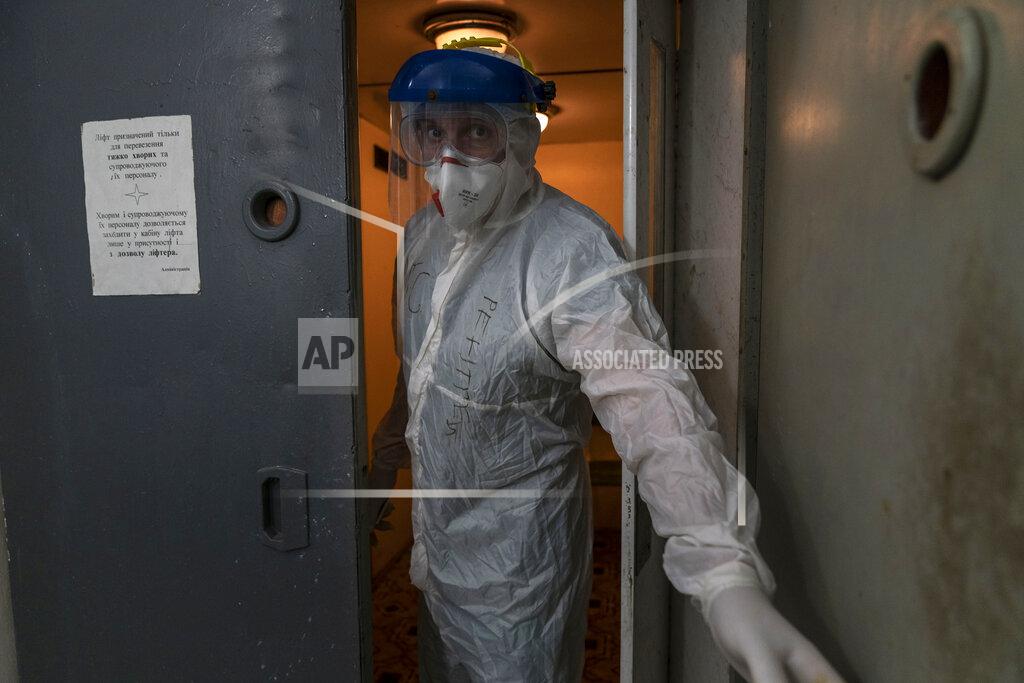 Evgeniy Maloletka Dr. Oleh Hornostayev closes an elevator door going into a red zone at the city hospital in Stryi, Ukraine, on Tuesday, Sept. 29 2020. Coronavirus infections in Ukraine began surging in late summer, and the ripples are hitting towns in the western part of the country. The government wants to avoid imposing a new lockdown, but officials acknowledge that the rising infections could make it necessary. (AP Photo/Evgeniy Maloletka)