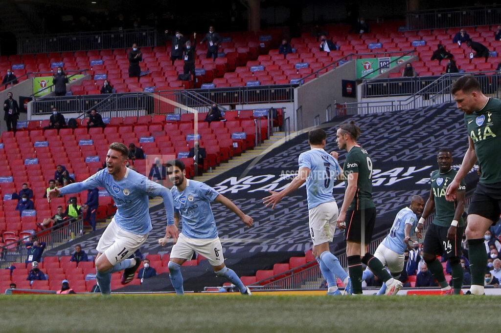 Alastair Grant Manchester City's Aymeric Laporte, left, celebrates after scoring the opening goal during the English League Cup final soccer match between Manchester City and Tottenham Hotspur at Wembley stadium in London, Sunday, April 25, 2021. (AP Photo/Alastair Grant)