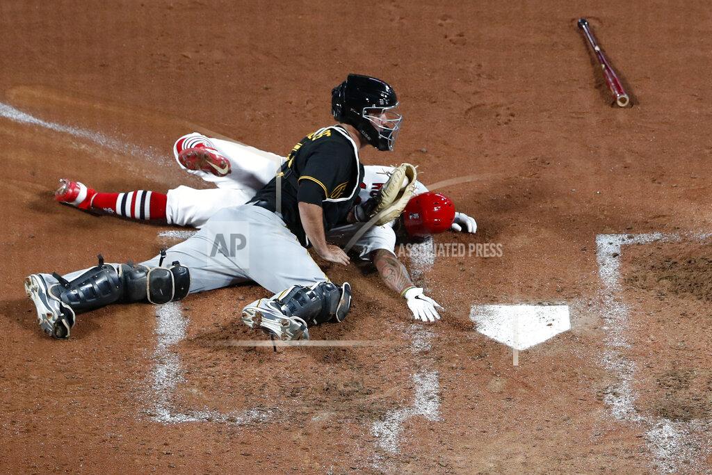Jeff Roberson St. Louis Cardinals' Kolten Wong is tagged out at home by Pittsburgh Pirates catcher Jacob Stallings, front, to end the fifth inning of a baseball game Friday, July 24, 2020, in St. Louis. (AP Photo/Jeff Roberson)