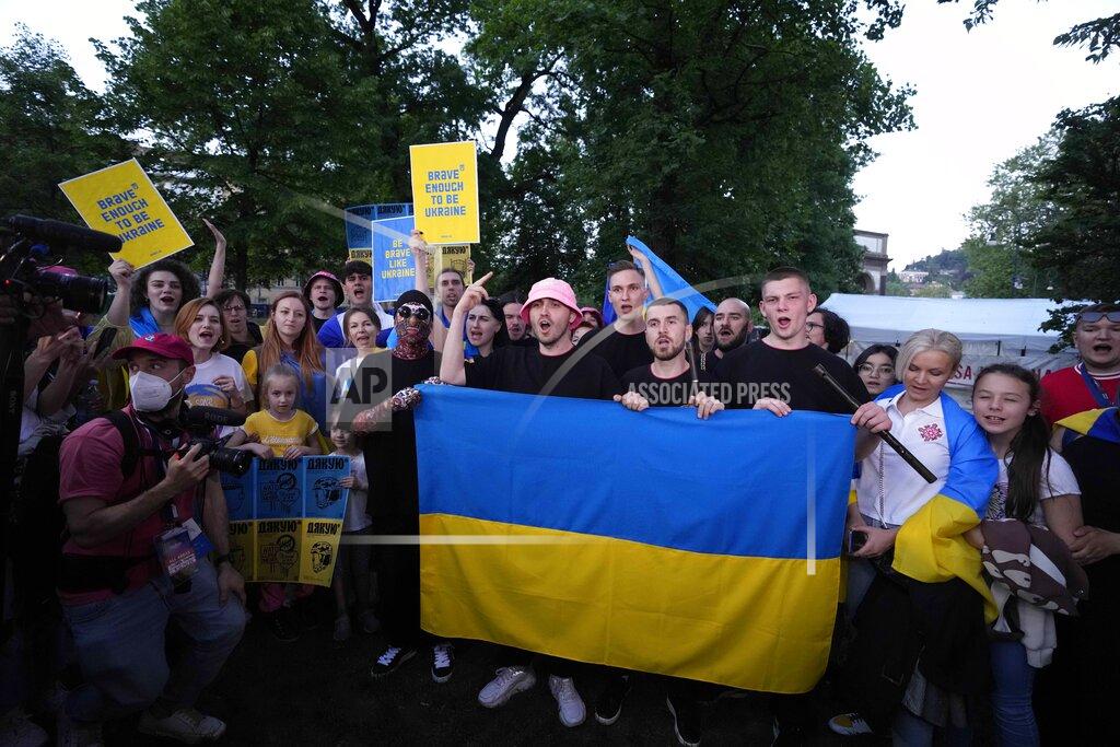 Luca Bruno Kalush Orchestra from Ukraine hold Ukrainian flag as they meet with Ukrainian community during a flash mob at the Eurovision Village in Turin, Italy, Wednesday, May 11, 2022. (AP Photo/Luca Bruno)