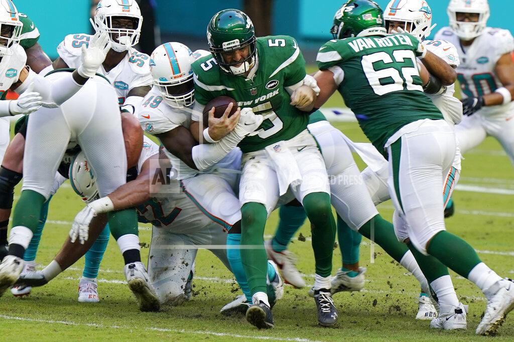 Wilfredo Lee FILE - In this Oct. 18, 2020, file photo, New York Jets quarterback Joe Flacco (5) is sacked by Miami Dolphins linebacker Sam Eguavoen (49) during the first half of an NFL football game, Sunday,, in Miami Gardens, Fla. The Dolphins' run defense makes even Sunday's matchup against the New York Jets potentially problematic. The Jets are 0-10 and lost 24-0 at Miami in Week 6, but they’re averaging a respectable 4.2 yards per carry and are sure to test the Dolphins' weakness. (AP Photo/Wilfredo Lee, File)