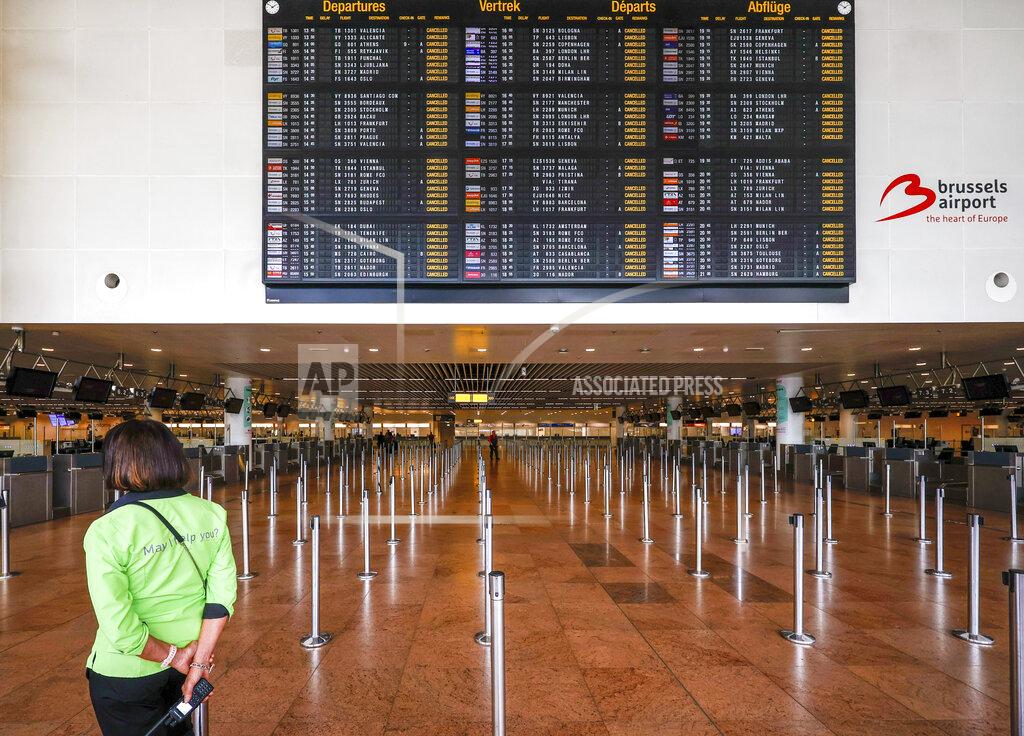 Olivier Matthys FILE - An employee stands under a departures board with cancelled flights in the departures hall at Brussels international airport during a general strike in Brussels, Monday, June 20, 2022. After two years of pandemic restrictions, travel demand is back with a vengeance but airlines and airports that slashed jobs during the depths of the COVID-19 crisis are struggling to keep up. With the busy summer tourism season underway in Europe, passengers are encountering chaotic scenes at airports, including lengthy delays, canceled flights and headaches over lost luggage. (AP Photo/Olivier Matthys, File)
