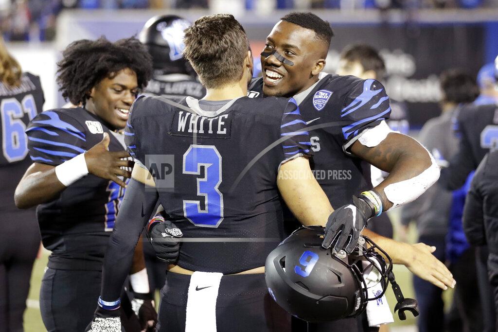 Mark Humphrey Memphis quarterback Brady White (3) hugs running back Patrick Taylor Jr. in the final minutes of the fourth quarter of an NCAA college football game against Cincinnati, Friday, Nov. 29, 2019, in Memphis, Tenn. (AP Photo/Mark Humphrey)