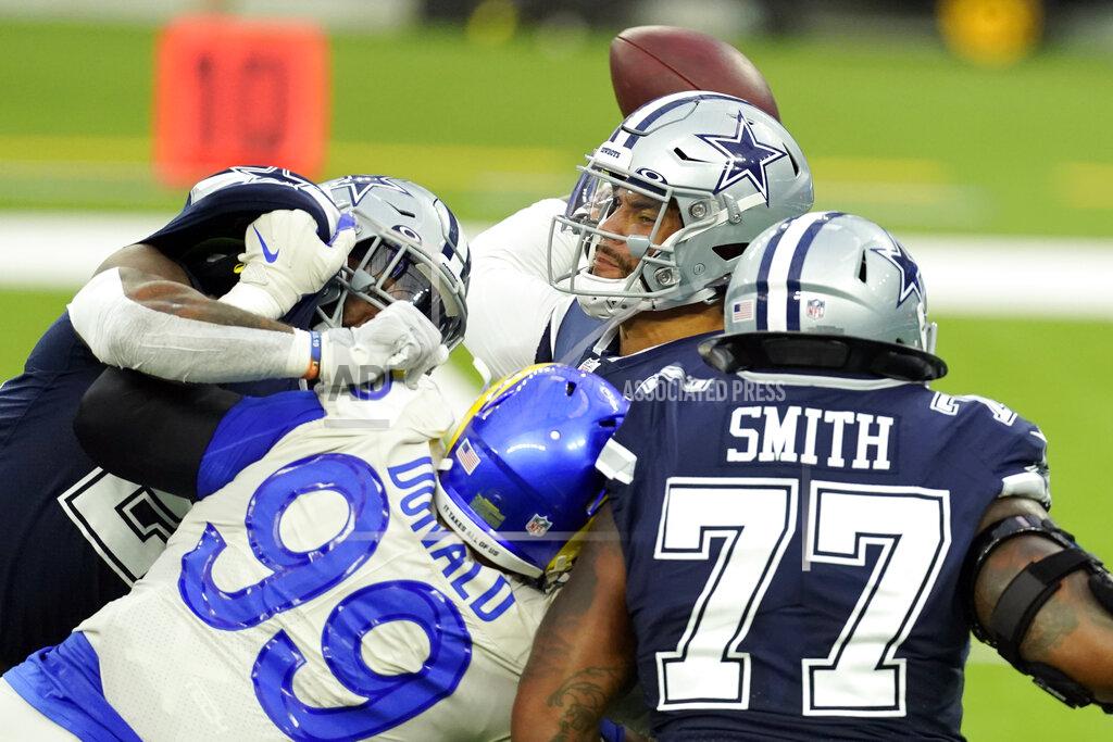Ashley Landis Dallas Cowboys quarterback Dak Prescott, top, throws under pressure from Los Angeles Rams defensive end Aaron Donald (99) during the first half of an NFL football game Sunday, Sept. 13, 2020, in Inglewood, Calif. (AP Photo/Ashley Landis )