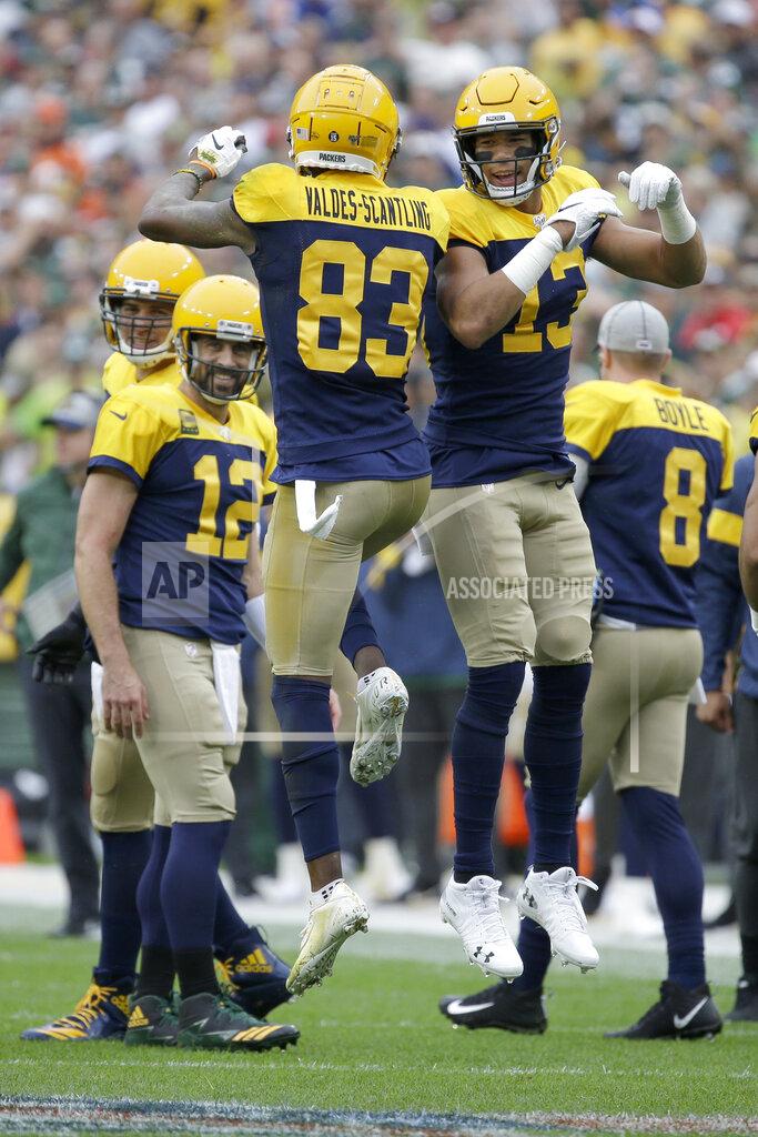 Mike Roemer Green Bay Packers wide receiver Marquez Valdes-Scantling (83) celebrates with Allen Lazard (13) after catching a touchdown pass as quarterback Aaron Rodgers (12) watches during the first half of an NFL football game against the Denver Broncos, Sunday, Sept. 22, 2019, in Green Bay, Wis. (AP Photo/Mike Roemer)