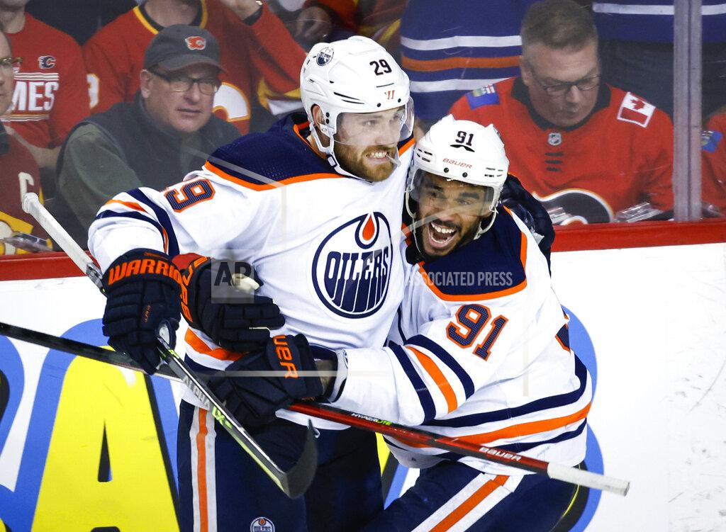 Jeff Mcintosh Edmonton Oilers center Leon Draisaitl, left, celebrates his goal against the Calgary Flames with Evander Kane during the third period of Game 2 of an NHL hockey Stanley Cup playoffs second-round series Friday, May 20, 2022, in Calgary, Alberta. (Jeff McIntosh/The Canadian Press via AP)