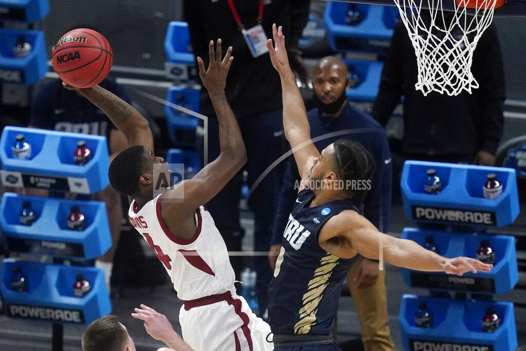 Darron Cummings Arkansas guard Davonte Davis, left, shoots over Oral Roberts forward Kevin Obanor, right, during the first half of a Sweet 16 game in the NCAA men's college basketball tournament at Bankers Life Fieldhouse, Saturday, March 27, 2021, in Indianapolis. (AP Photo/Darron Cummings)