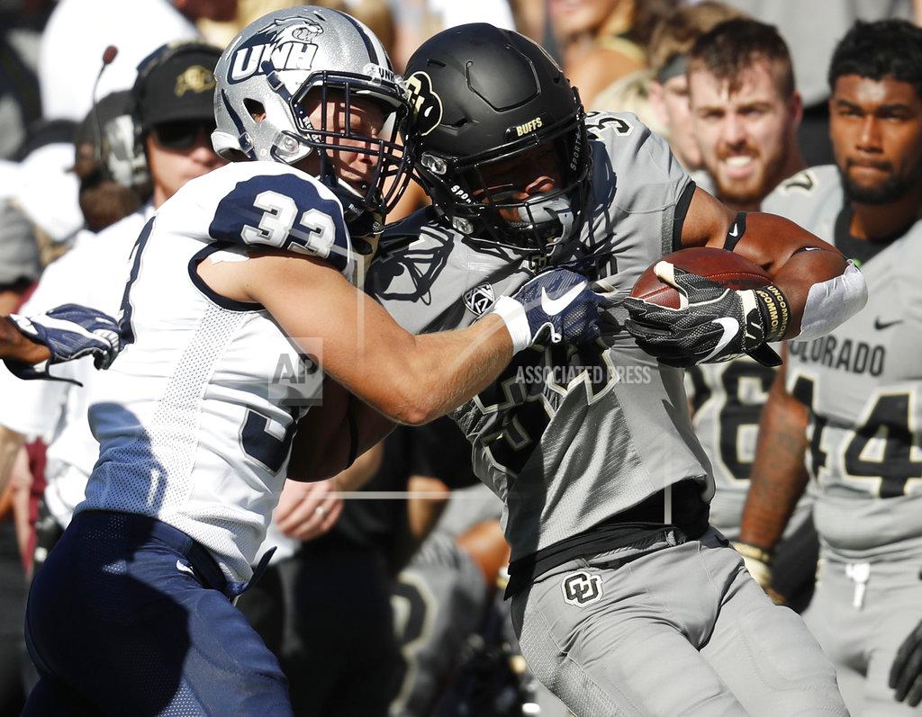 David Zalubowski New Hampshire safety Evan Horn, left, tackles Colorado running back Travon McMillian after a short gain in the first half of an NCAA college football game Saturday, Sept. 15, 2018, in Boulder, Colo. (AP Photo/David Zalubowski)