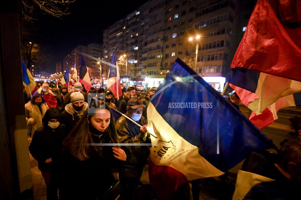 Andreea Alexandru Protesters waving flags march after a deadly fire at a hospital treating COVID-19 patients in Bucharest, Romania, Saturday, Jan. 30, 2021. Hundreds marched during a protest organized by the AUR alliance demanding the resignation of several top officials, after a fire early Friday at a key hospital in Bucharest that also treats COVID-19 patients killed five people. (AP Photo/Andreea Alexandru)