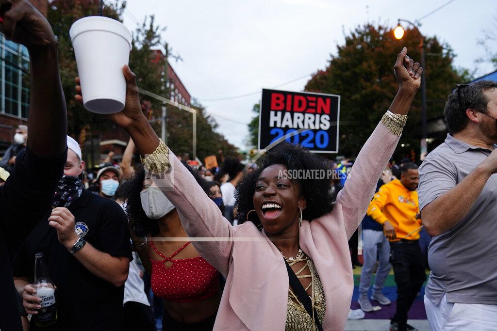 Brynn Anderson Supporters celebrate the victory of President- elect Democrat Joe Biden, Saturday, Nov. 7, 2020, in Atlanta. Biden defeated President Donald Trump to become the 46th president of the United States, positioning himself to lead a nation gripped by the historic pandemic and a confluence of economic and social turmoil. (AP Photo/Brynn Anderson)