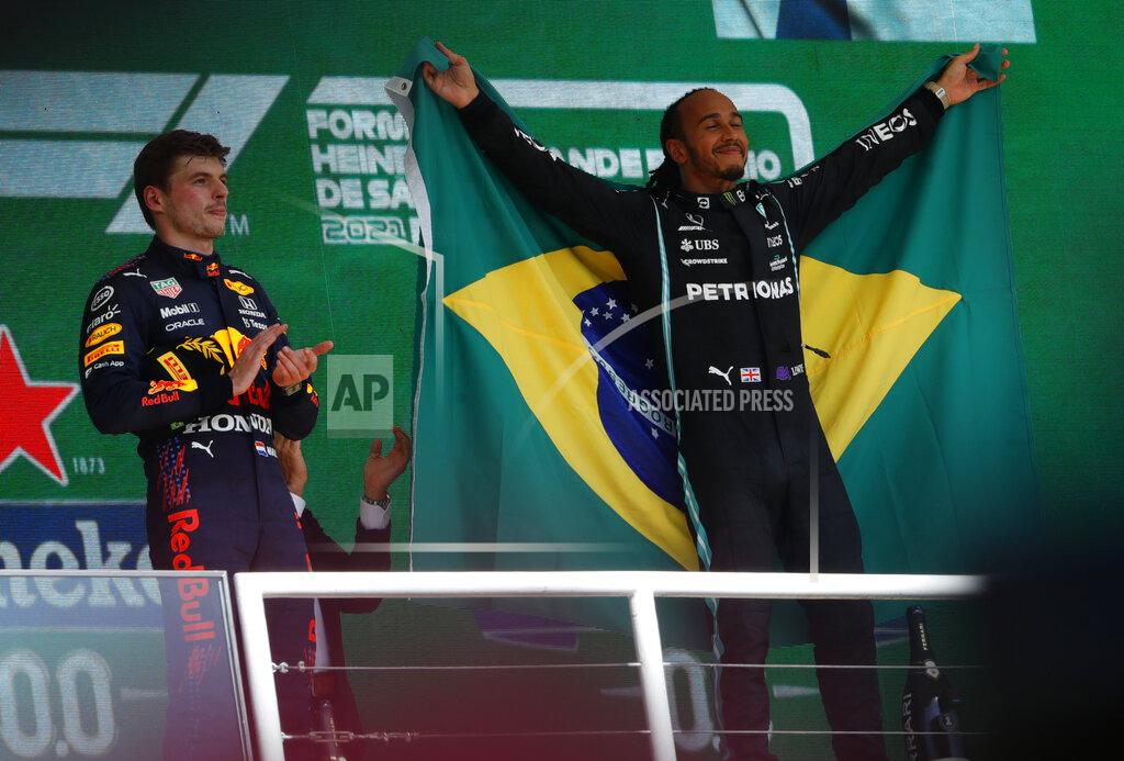 Marcelo Chello Mercedes driver Lewis Hamilton, of Britain, right, celebrates his victory over Red Bull driver Max Verstappen, of The Netherlands, right, in the Brazilian Formula One Grand Prix at the Interlagos race track in Sao Paulo, Brazil, Sunday, Nov. 14, 2021. Max Verstappen finished second. (AP Photo/Marcelo Chello)