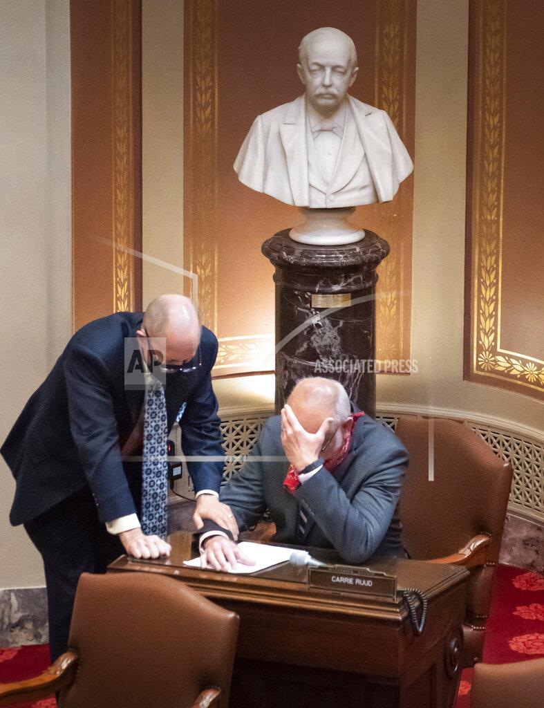 Senate Majority Leader Paul Gazelka, left, R-East Gull Lake, speaks with Sen. Roger Chamberlain, R-Lino Lakes, regarding the bonding bill, Thursday, Oct. 15, 2020, in St. Paul, Minn. The Minnesota Senate easily passed a nearly $1.9 billion public works construction package Thursday, a day after the House finally broke months of partisan stalemate and approved the bill. (Glen Stubbe/Star Tribune via AP)