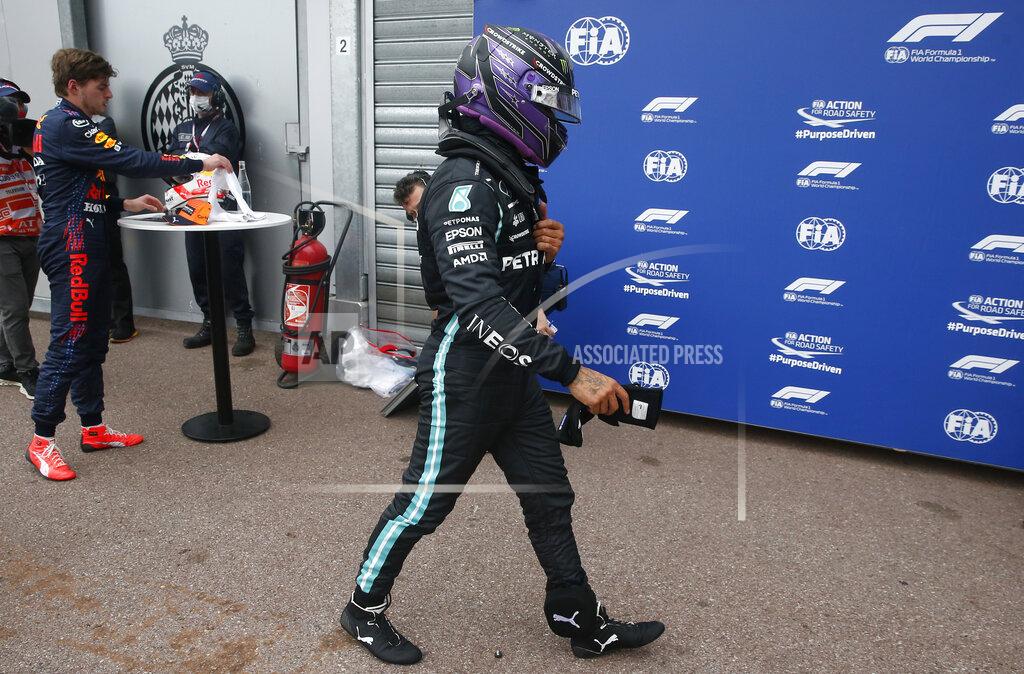 Sebastian Nogier Mercedes driver Lewis Hamilton of Britain walks near his team garage after the qualifying session at the Monaco racetrack, in Monaco, Saturday, May 22, 2021. The Formula One race will take place on Sunday with Ferrari driver Charles Leclerc of Monaco in pole position. (Sebastien Nogier, Pool via AP)