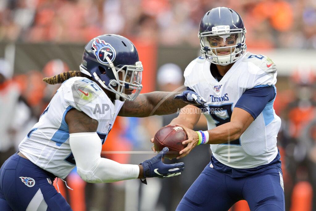 David Richard Tennessee Titans quarterback Marcus Mariota (8) hands off the ball to running back Derrick Henry (22) for a 1-yard touchdown during the first half in an NFL football game against the Cleveland Browns, Sunday, Sept. 8, 2019, in Cleveland. (AP Photo/David Richard)