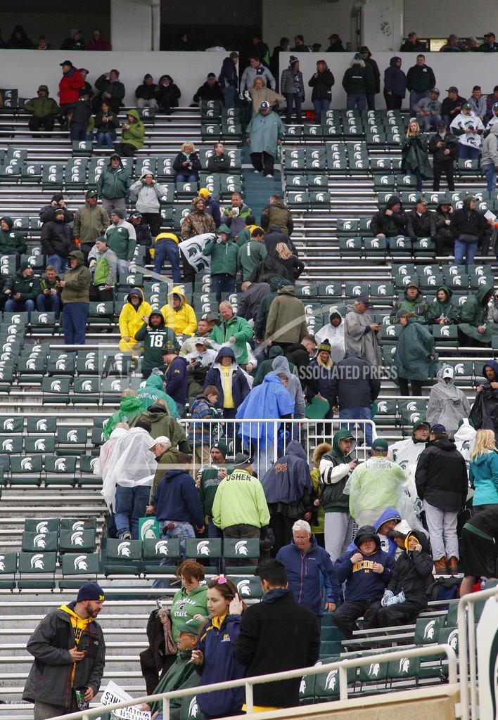 Al Goldis Fans begin to return to their seats in Spartan Stadium following a weather delay in the Michigan-Michigan State NCAA college football game, Saturday, Oct. 20, 2018, in East Lansing, Mich. (AP Photo/Al Goldis)