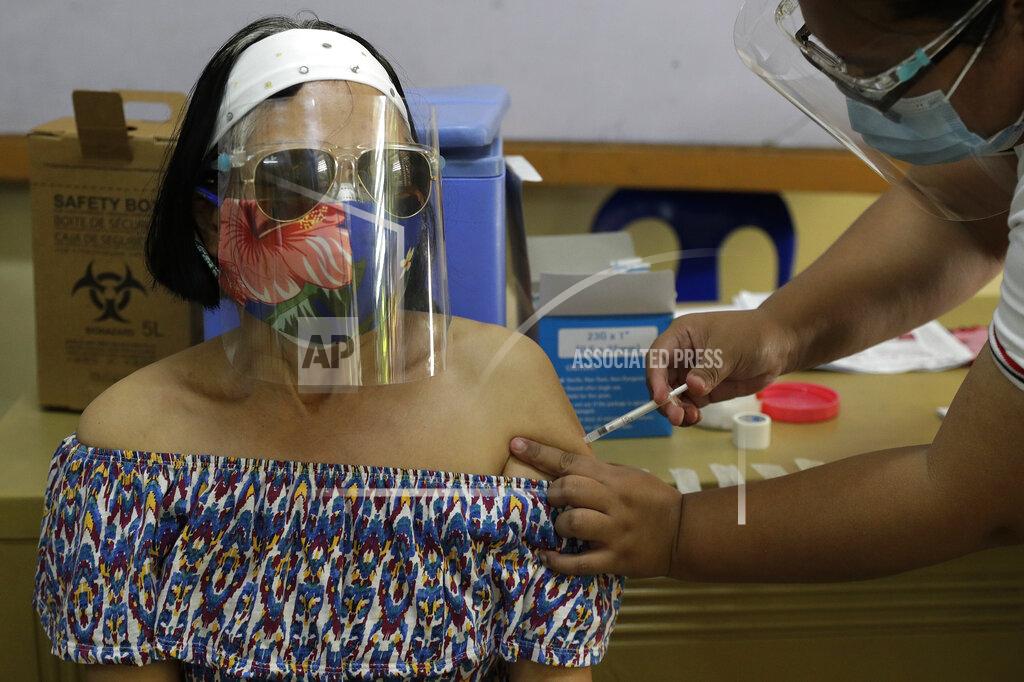 Aaron Favila Filipino nurse Monette Villaraza gets China's Sinovac vaccine for COVID-19 under a government program at a school in Quezon City, Philippines, Tuesday March 30, 2021. Philippine officials placed Metropolitan Manila and four outlying provinces, a region of more than 25 million people, back to a lockdown Monday at the height of the Lenten and Easter holiday travel season as they scrambled to control an alarming surge in coronavirus infections. (AP Photo/Aaron Favila)
