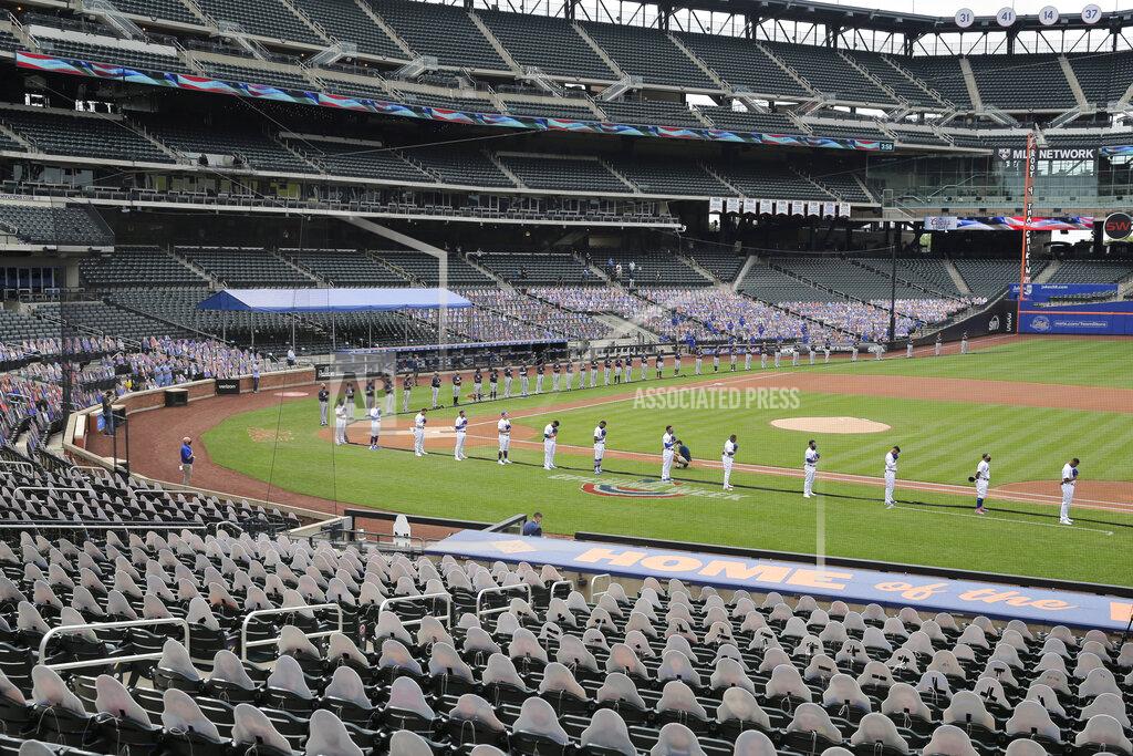 Seth Wenig New York Mets, foreground, and Atlanta Braves players line up in a mostly empty stadium before their opening day baseball game at Citi Field, Friday, July 24, 2020, in New York. (AP Photo/Seth Wenig)