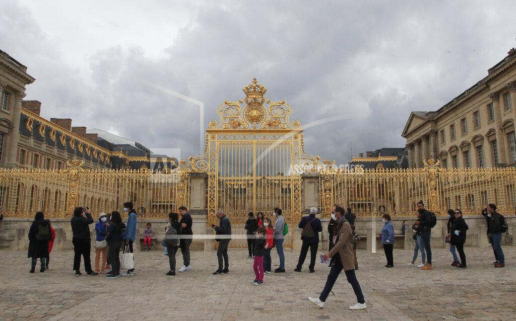 Michel Euler People lining up along the Gate of Honor to visit the Chateau de Versailles, west Paris, Sunday, June 7, 2020. The Chateau de Versailles was reopened on June 6, after Covid-19 closure. (AP Photo/Michel Euler)