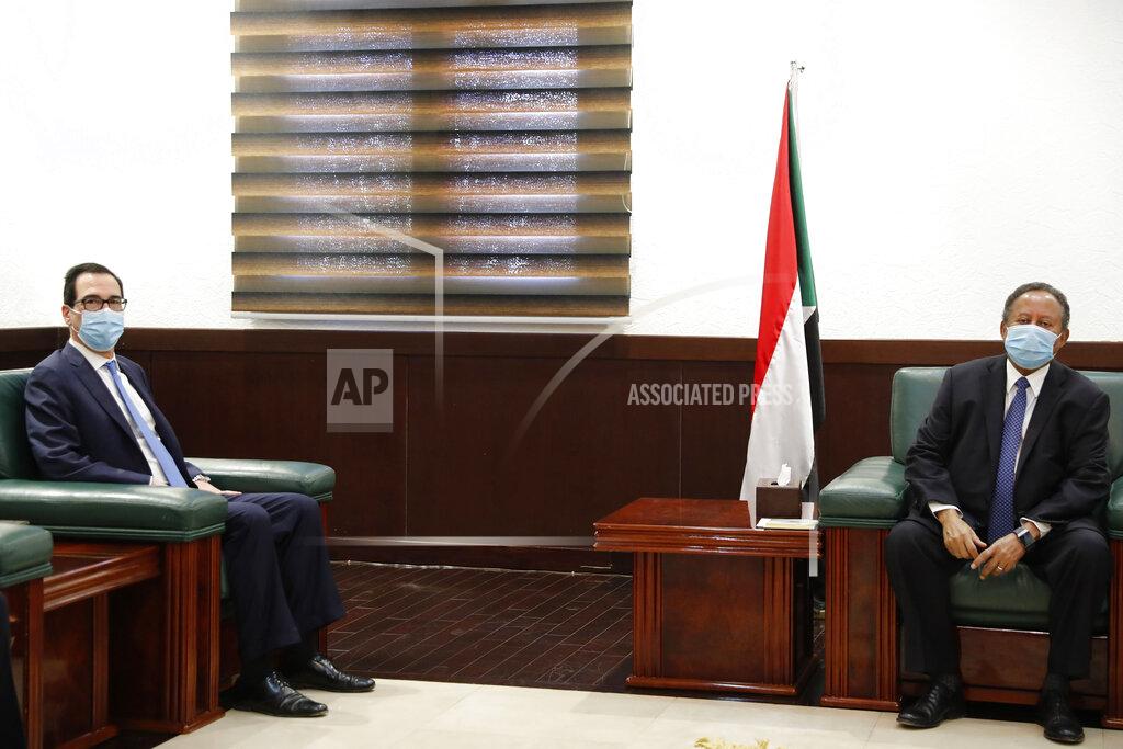 Uncredited Sudanese Prime Minister Abdullah Hamdok, right, meets with US Treasury Secretary Steven Mnuchin in the Cabinet Building, in Khartoum, Sudan, Wednesday, Jan. 6, 2021. The U.S. and Sudan have agreed to settle the African country's debt to the World Bank. The move comes after Mnuchin arrived in Sudan, the first visit by a senior American official since President Donald trump removed Sudan from the list of state sponsors of terrorism. (AP Photo)