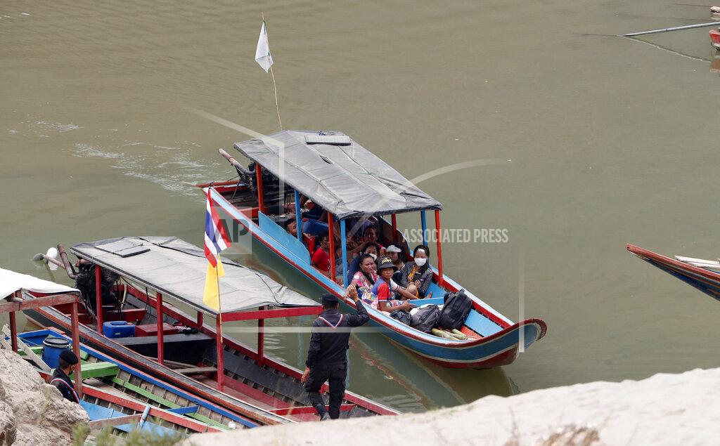 Sakchai Lalit Karenni villagers from Myanmar arrive on a boat with an injured person as they evacuate to Ban Mae Sam Laep Health Center in Mae Hong Son province, northern Thailand on Tuesday March 30, 2021. Thai soldiers began sending back some of the thousands of people who have fled a series of airstrikes by the military in neighboring Myanmar, people familiar with the matter said Monday. But Thai officials denied that as the insecurity on the border added a new dimension to an already volatile crisis set off by a coup in Myanmar. (AP Photo/Sakchai Lalit)
