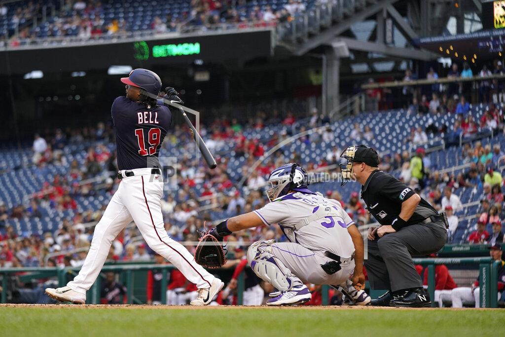 Patrick Semansky Washington Nationals' Josh Bell, left, doubles in front of Colorado Rockies catcher Elias Diaz and home plate umpire Sean Barber in the first inning of a baseball game, Thursday, May 26, 2022, in Washington. Keibert Ruiz scored on the play. (AP Photo/Patrick Semansky)