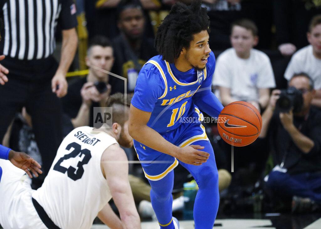 David Zalubowski UCLA guard Tyger Campbell, right, picks up the ball after it was turned over by Colorado forward Lucas Siewert in the first half of an NCAA college basketball game Saturday, Feb. 22, 2020, in Boulder, Colo. (AP Photo/David Zalubowski)