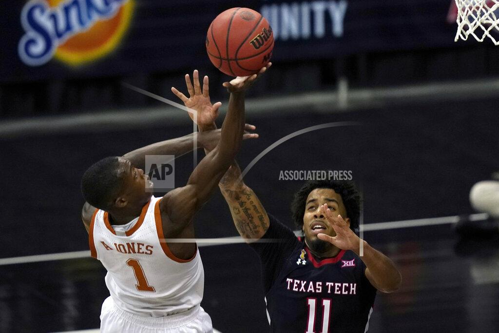 Orlin Wagner Texas guard Andrew Jones (1) shoots over Texas Tech guard Kyler Edwards (11) during the second half of an NCAA college basketball game in the quarterfinal round of the Big 12 men's tournament in Kansas City, Mo., Thursday, March 11, 2021. Texas defeated Texas Tech 67-66. (AP Photo/Orlin Wagner)