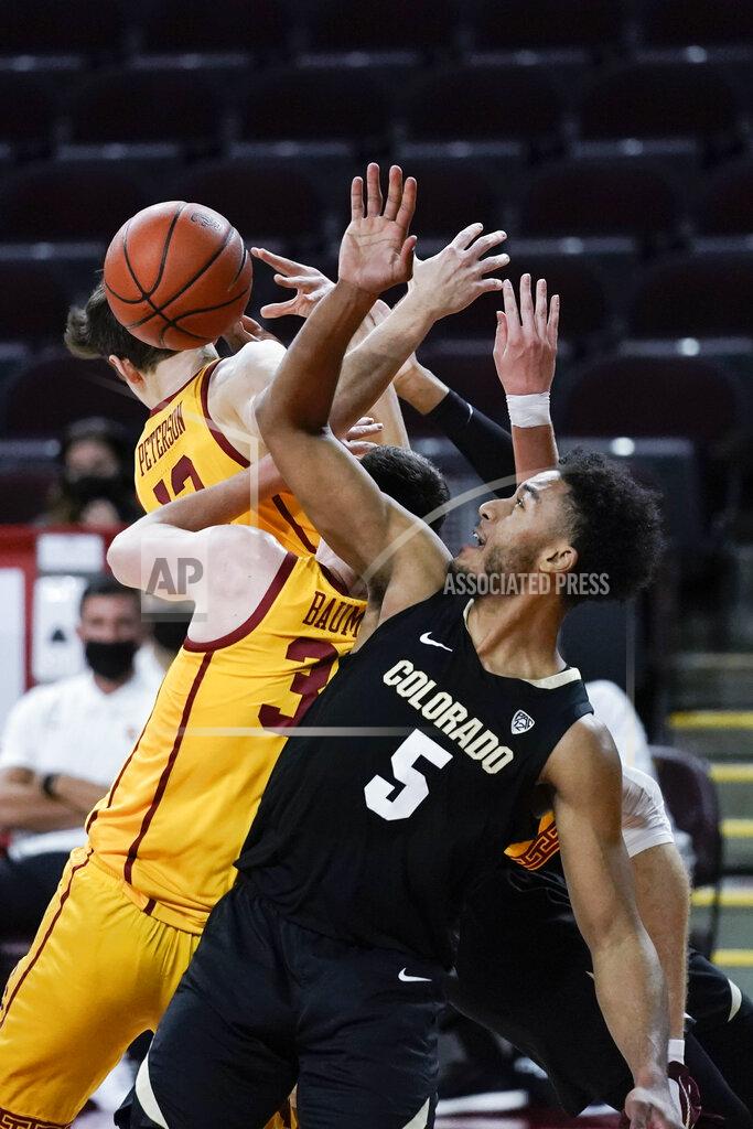 Jae C. Hong Colorado's D'Shawn Schwartz, front, vies for a rebound with Southern California's Drew Peterson, top left, and Noah Baumann during the first half of an NCAA college basketball game Thursday, Dec. 31, 2020, in Los Angeles. (AP Photo/Jae C. Hong)