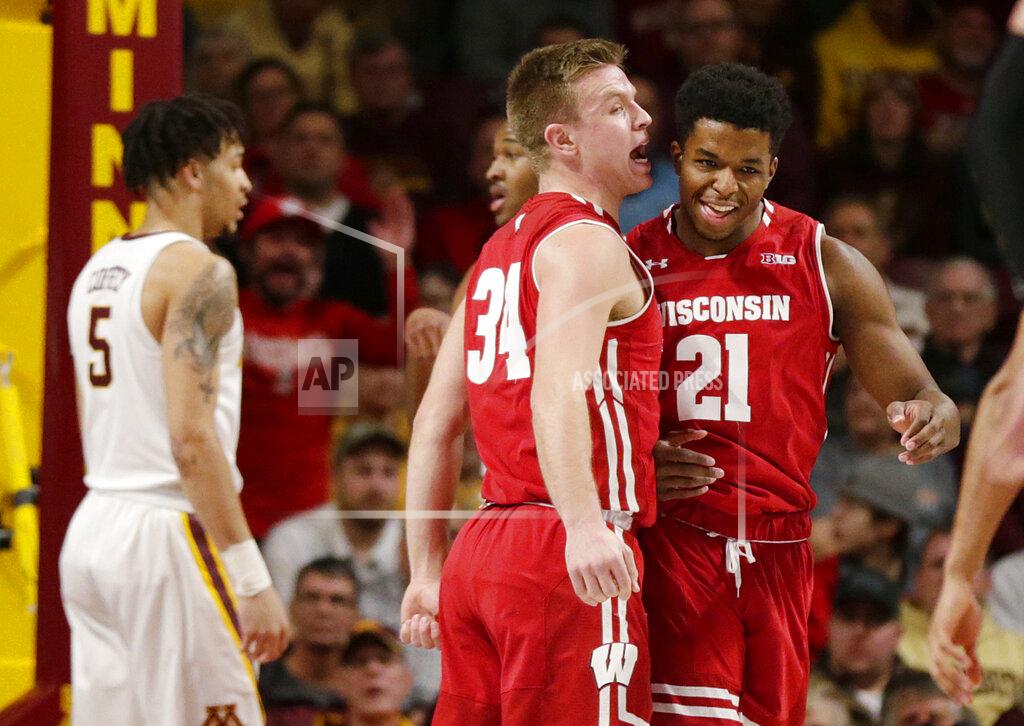 Andy Clayton-King Wisconsin guard Brad Davison (34) yells to forward Kahlil Iverson after Iverson dunked and was fouled, while Minnesota guard Amir Coffey (5) stands nearby, during the first half of an NCAA college basketball game Wednesday, Feb. 6, 2019, in Minneapolis. (AP Photo/Andy Clayton-King)