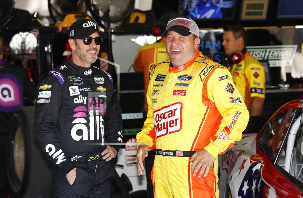Carlos Osorio Jimmie Johnson, left, meets with Ryan Newman in the garage before practice for a NASCAR cup series auto race at Michigan International Speedway, Friday, June 7, 2019, in Brooklyn, Mich. (AP Photo/Carlos Osorio)