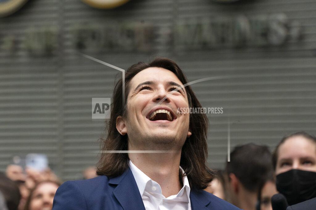 Mark Lennihan Vladimir Tenev, CEO and Co-Founder of Robinhood, celebrates in New York's Times Square following his company's IPO, Thursday, July 29, 2021. Robinhood is selling its own stock on Wall Street, the very place the online brokerage has rattled with its stated goal of democratizing finance. Through its app, Robinhood has introduced millions to investing and reshaped the brokerage industry, all while racking up a long list of controversies in less than eight years. (AP Photo/Mark Lennihan)