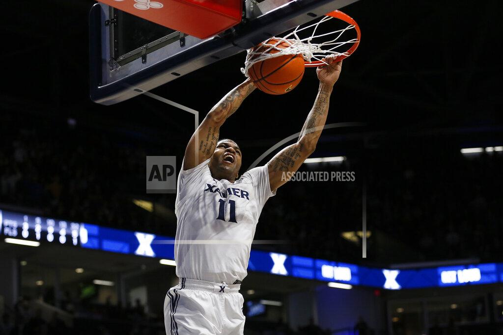 Sam Greene Xavier guard Dwon Odom (11) dunks against Marquette in the first half of an NCAA college basketball game at Cintas Center in Cincinnati on Saturday, Dec. 18, 2021. (Sam Greene/The Cincinnati Enquirer via AP)