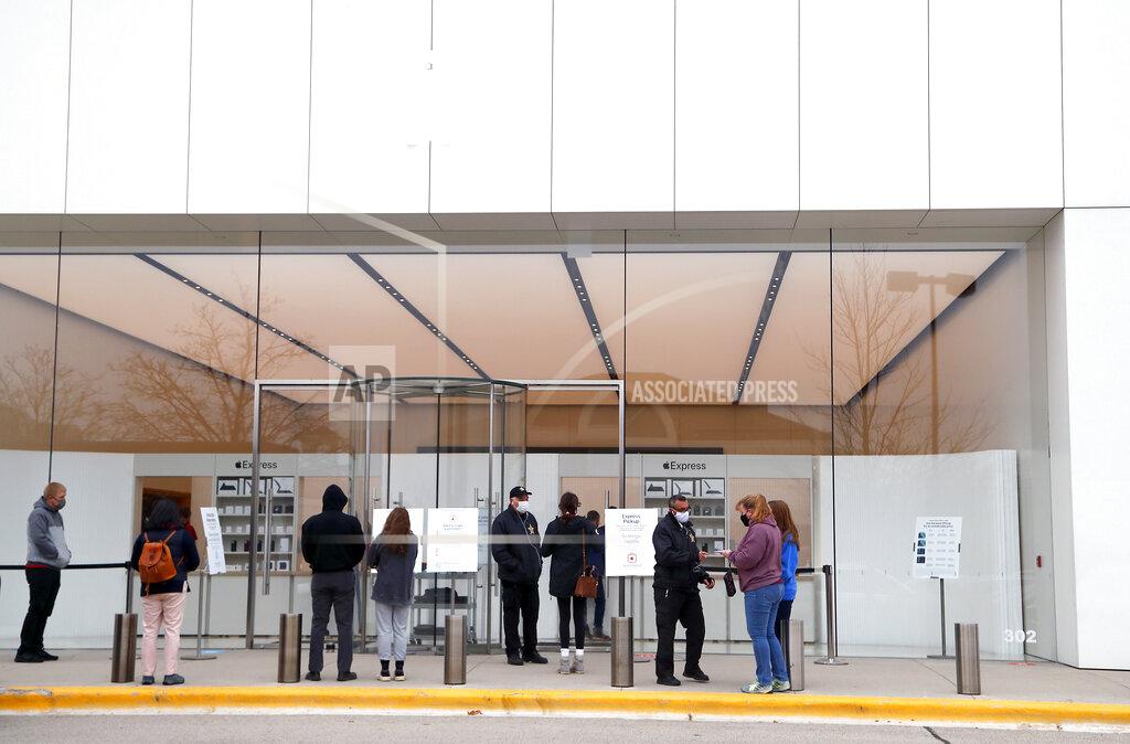 Brian Hill Customers wait to get into the Apple store for appointments during Black Friday shopping outdoors at Deer Park Town Center Friday, Nov. 27, 2020, in Deer Park, Ill. (Brian Hill/Daily Herald via AP)
