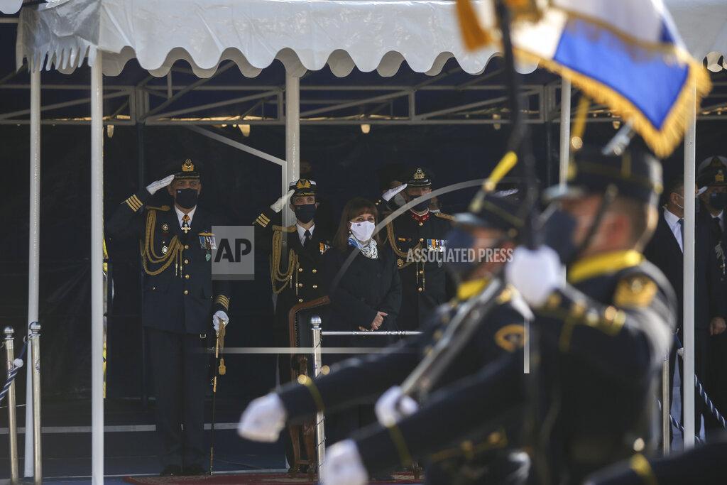 Giannis Papanikos Greek President Katerina Sakellaropoulou, center, watches the military parade, in the northern port city of Thessaloniki, Greece, Greece, on Thursday, Oct. 28, 2021. The parade is held to celebrate Greece's refusal to align itself with a belligerent fascist Italy in 1940 and instead fight a much stronger opponent, a decision which dragged it into World War II and eventually led to a brutal occupation by Nazi Germany. (AP Photo/Giannis Papanikos)
