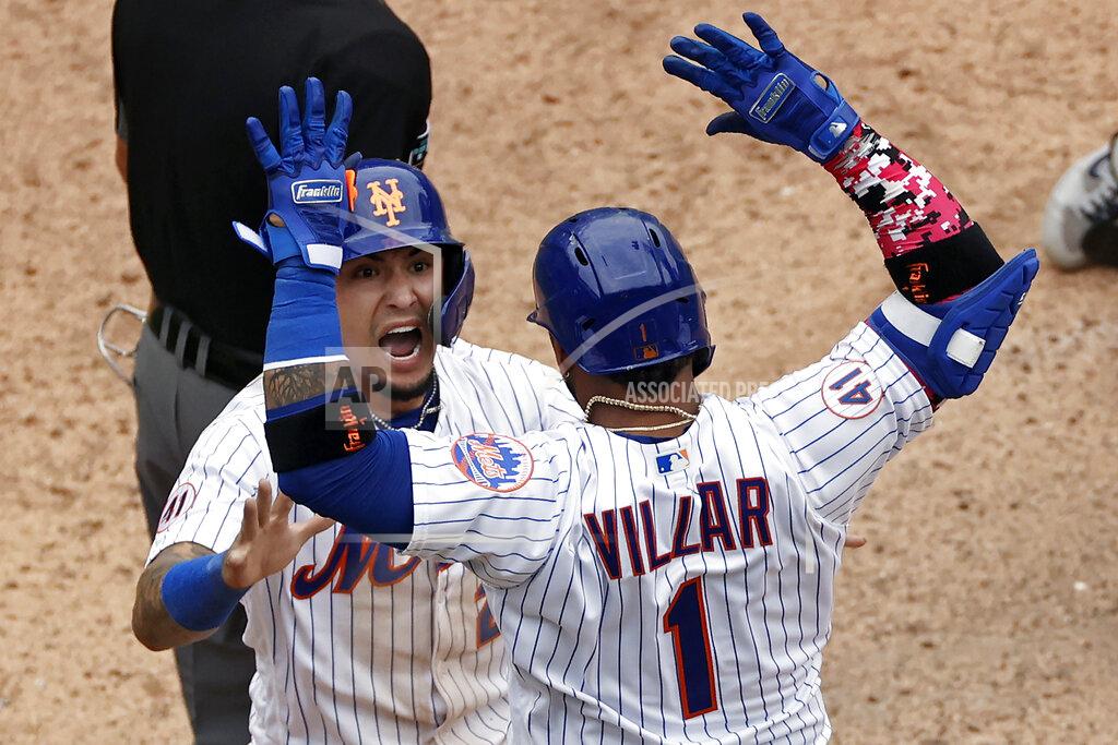 Adam Hunger New York Mets' Javier Baez celebrates with Jonathan Villar after scoring the game winning run against the Miami Marlins during the ninth inning of the first game of a baseball doubleheader that started April 11 and was suspended because of rain, Tuesday, Aug. 31, 2021, in New York. The Mets won 6-5. (AP Photo/Adam Hunger)