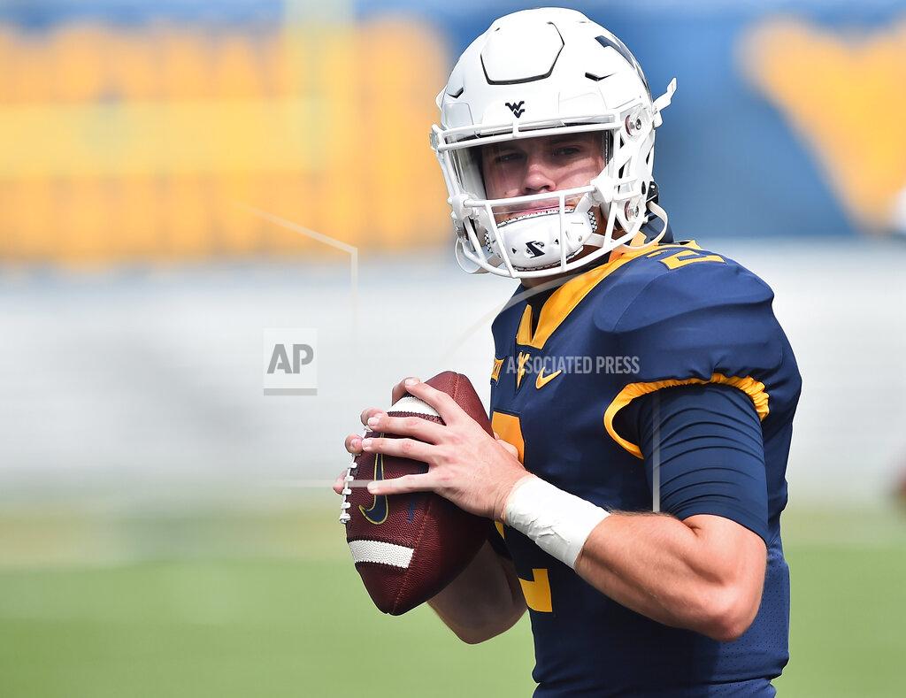William Wotring/ The Dominion Post West Virginia quarterback Jarret Doege (2) warms up before an NCAA college football game against Eastern Kentucky on Saturday, Sept. 12, 2020, in Morgantown, W.Va. (William Wotring/The Dominion-Post via AP)